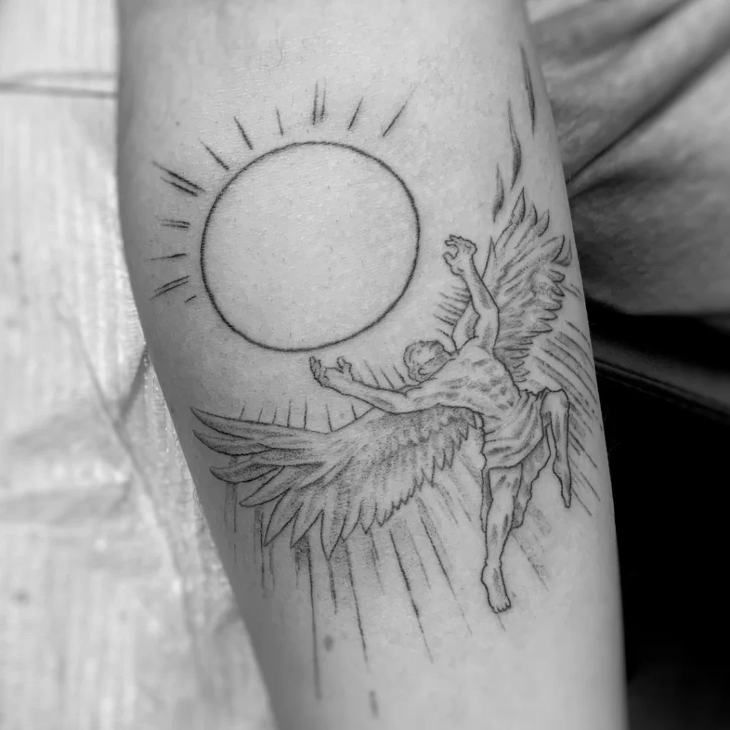 Black and grey tattoo of Icarus falling before the sun on forearm