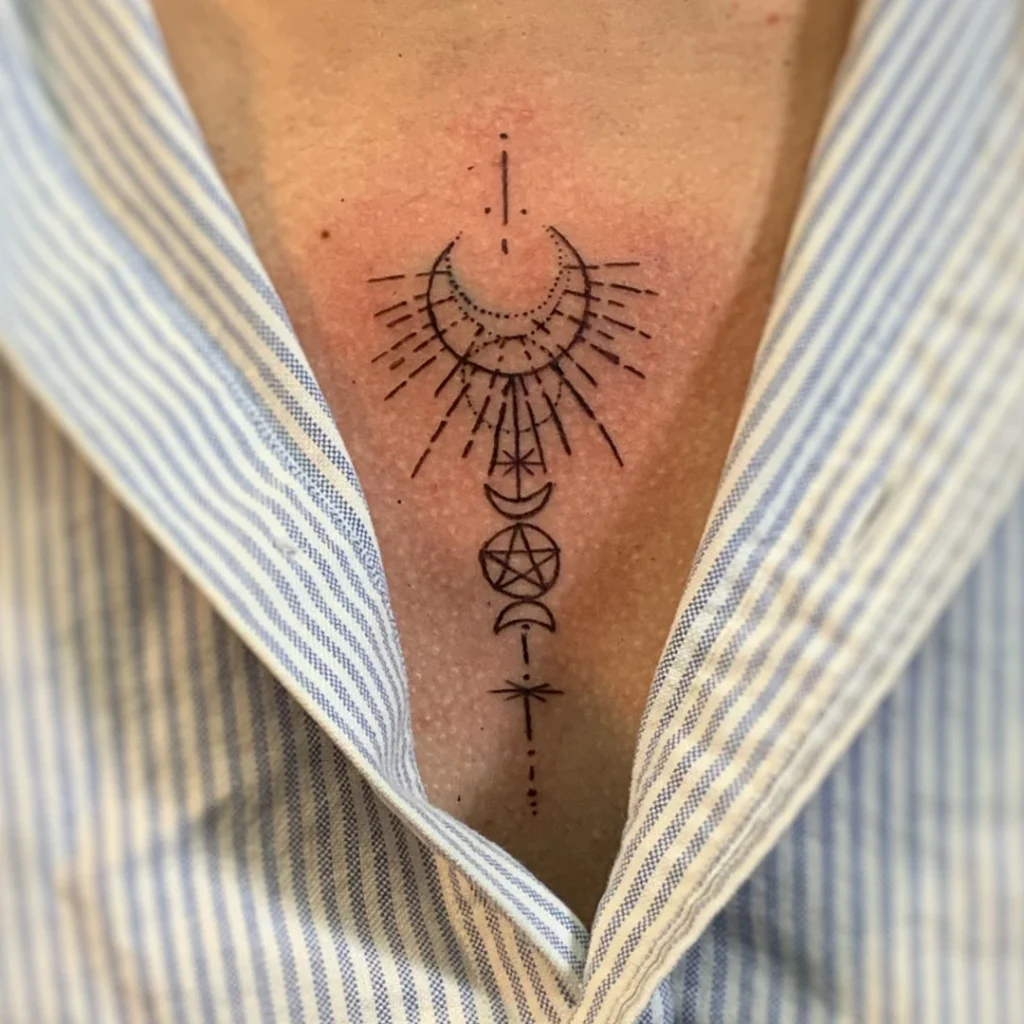 Fine line sternum tattoo of crescent moon symbols