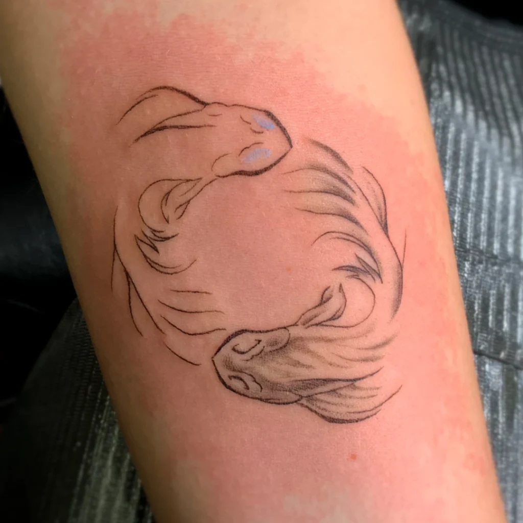 A forearm tattoo of brushstroke koi following each other's tails.